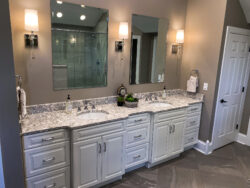 Bathroom remodel with double vanity, quartz counters, and LED mirrors by Sablotny Floors in Jacksonville IL