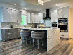 Modern kitchen remodel with island seating, quartz countertops, and hardwood floors installed by Sablotny Floors in Central Illinois