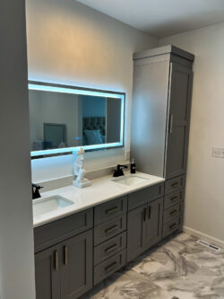 Primary bathroom remodel with large vanity, built-in storage tower, and LED mirror by Sablotny Floors