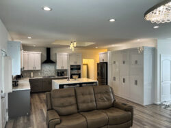 Kitchen renovation featuring stained wood cabinets, quartz countertops, and stainless appliances by Sablotny Floors