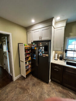 Sablotny Floors kitchen organization featuring pullout spice racks and utensil storage solutions