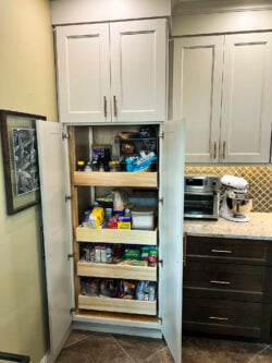 Sablotny Floors kitchen organization featuring pullout spice racks and utensil storage solutions