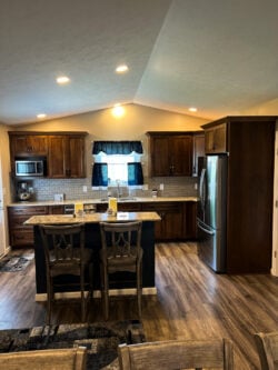Sablotny Floors kitchen remodel with shaker cabinets, island seating, and stainless appliances in Jacksonville IL