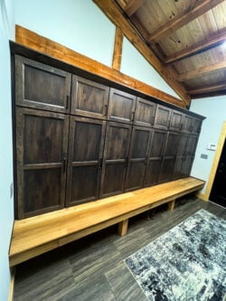 Custom mudroom cabinetry by Sablotny Floors featuring dark wood storage bench in Central Illinois